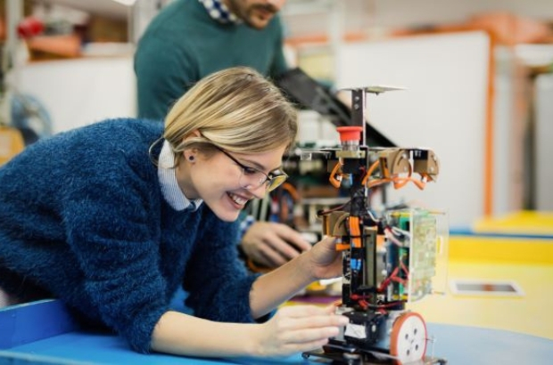 young woman engineer working on robotics project