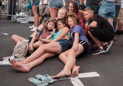 Family taking a selfie during a downtown festival.