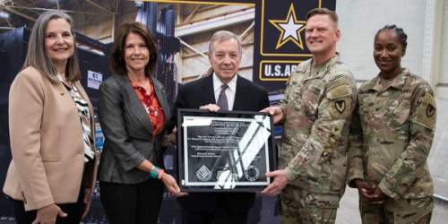 Photo of presentation of plaque to U.S. Rep. Cheri Bustos and U.S. Sen. Dick Durbin