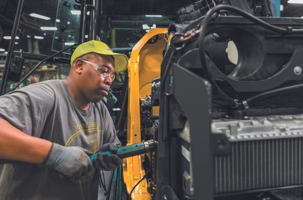 John Deere employee building a tractor.