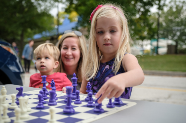Little girl playing chess
