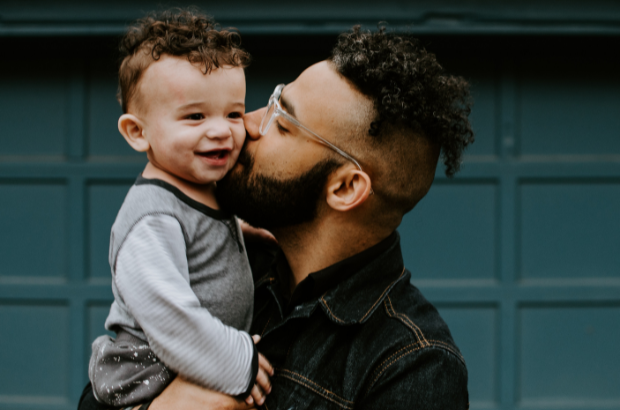 Father kissing son on the cheek